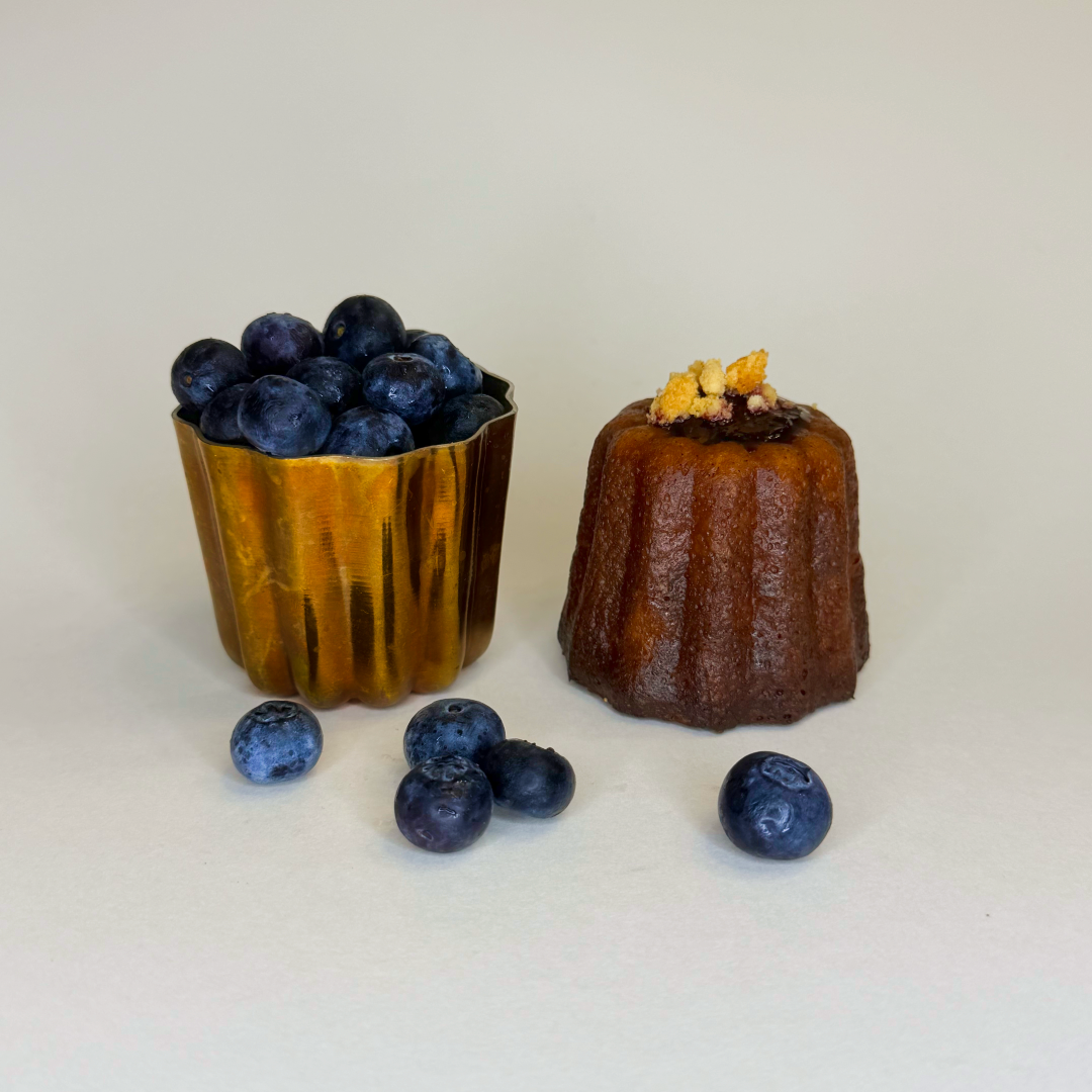 Canele with blueberries on a white background